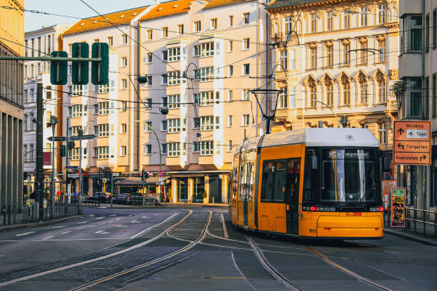 Yellow public transportation tram passing by the city of Berlin stock photo