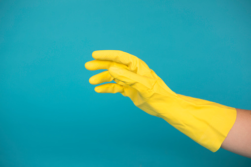 Yellow Rubber Glove On A Blue Background Stock Photo - Download Image ...