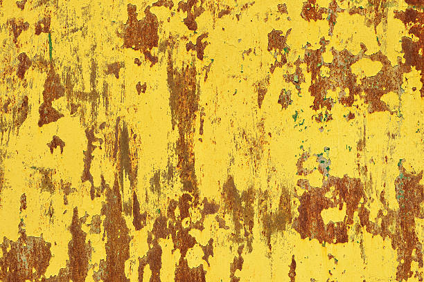 Yellow rust on a metal wall, the old background stock photo