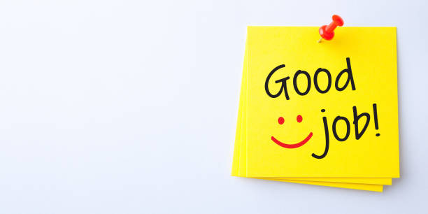 Yellow Sticky Note With Good Job And Red Push Pin On White Background stock photo