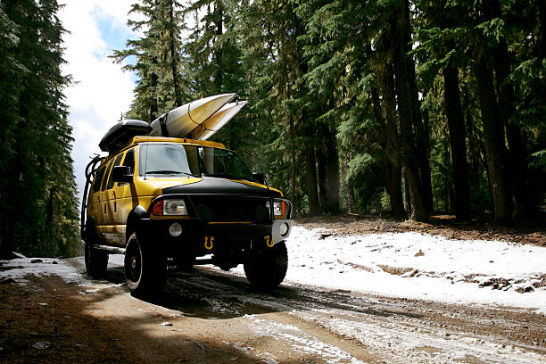 Yellow Van on snow road stock photo