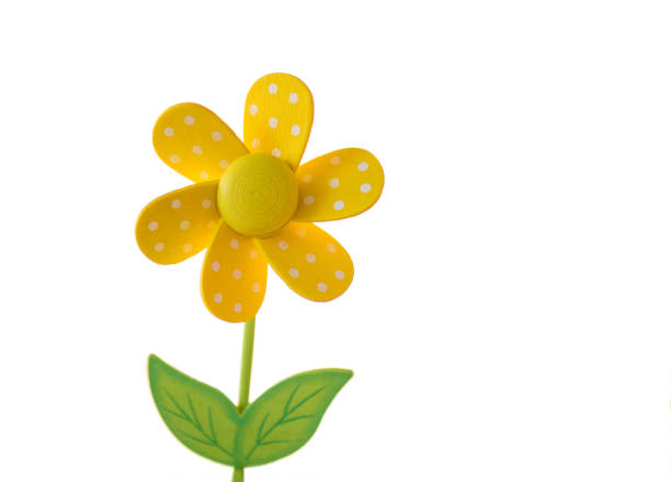 yellow wooden daisy toy stock photo
