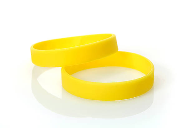 Yellow Wristband Two Yellow Wristbands bracelet stock pictures, royalty-free photos & images