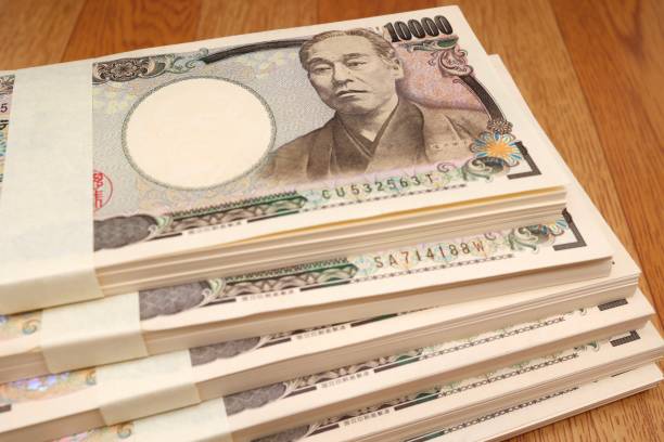 10,000 yen bills A large quantity of Japanese 10,000 yen bills. Multiple wads of bills. BANK OF JAPAN   stock pictures, royalty-free photos & images