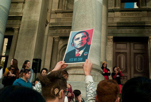 Adelaide, Australia - May 12th, 2012: A man holds up a poster of Barack Obama that says \