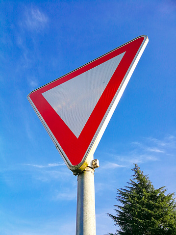 german Give way priority yield road traffic roadsign Over a Blue Sky