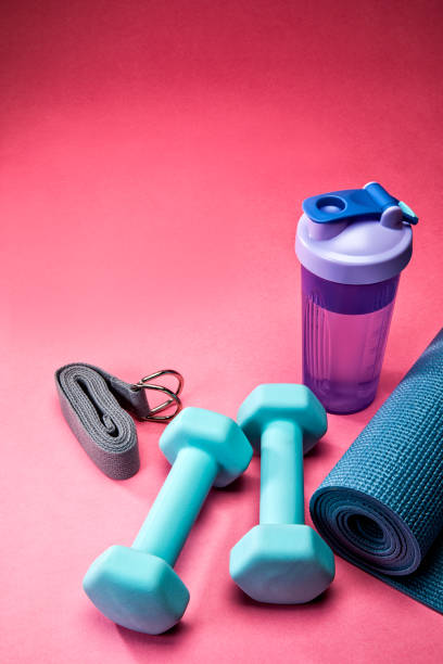 Yoga and Fitness Equipment on Pink Background stock photo