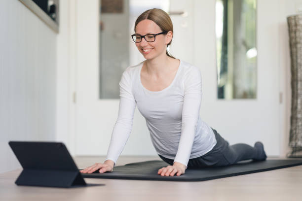 Yoga at home with online course stock photo