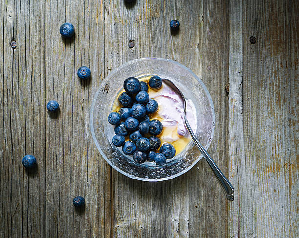 Yogurt with honey and fresh blueberries stock photo