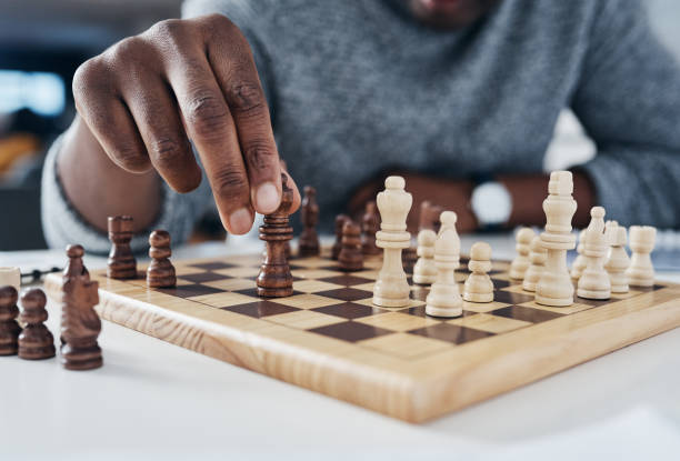 You only win by knowing your opponent's next move Shot of an unrecognizable businessman playing chess in his office chess stock pictures, royalty-free photos & images