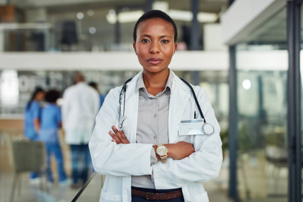 You won't need a second opinion with her expertise Portrait of a doctor standing in a hospital female doctor stock pictures, royalty-free photos & images