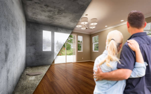 Young Adult Couple Looking At Before and After Remodelling of Empty Room In House. stock photo