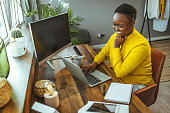 istock Young African American woman at home, working or studying. 1366405614