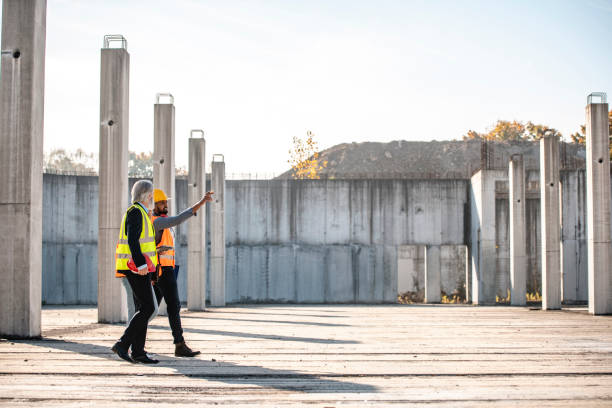 Young African Construction Foreman Leading Site Walk-Through stock photo
