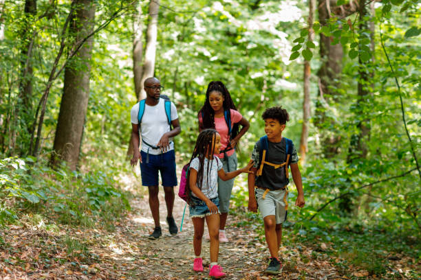 Young African Family Enjoying The Beauty Of The Woods stock photo