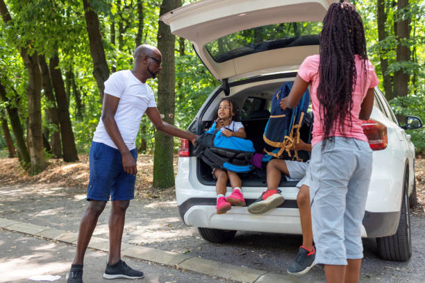 Young African Family Getting Ready For Hiking From Car stock photo