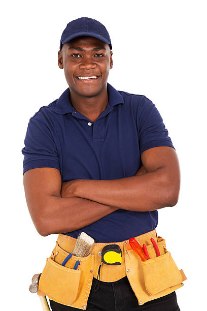 young african repairman looking at the camera smiling young african repairman looking at the camera african american plumber stock pictures, royalty-free photos & images