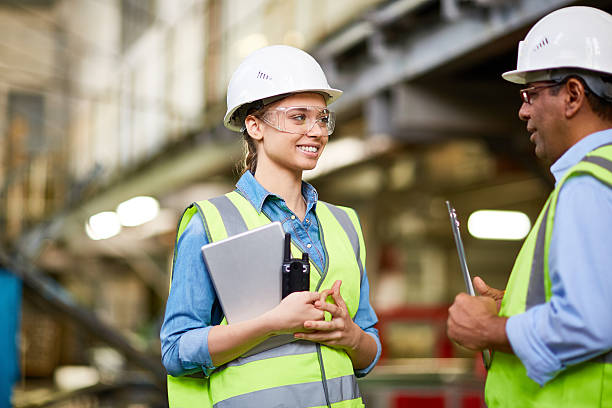 Young apprentice Technician inspecting a young trainee at factory engineering courses stock pictures, royalty-free photos & images