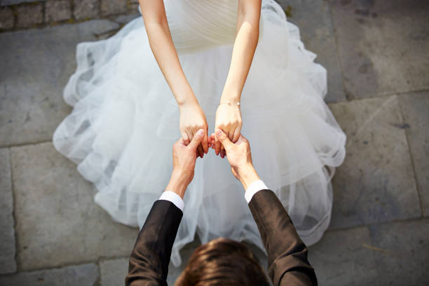 young asian adults dancing in wedding dress stock photo