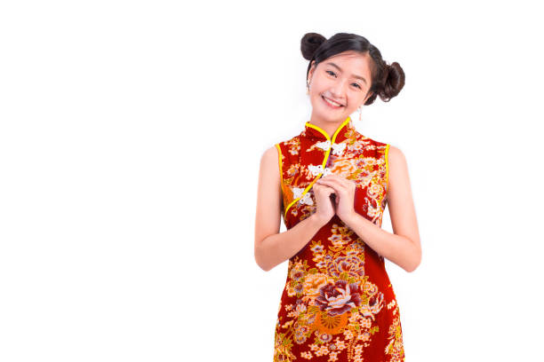 Young Asian beauty woman wearing cheongsam and blessing or greeting gesture in Chinese new year festival event on isolated white background. Holiday and Lifestyle concept. Qipao dress wearing Young Asian beauty woman wearing cheongsam and blessing or greeting gesture in Chinese new year festival event on isolated white background. Holiday and Lifestyle concept. Qipao dress wearing chinese girl hairstyle stock pictures, royalty-free photos & images