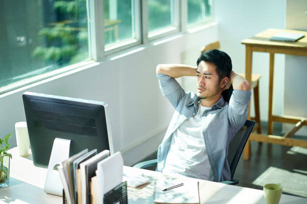 young asian business man facing challenge stock photo