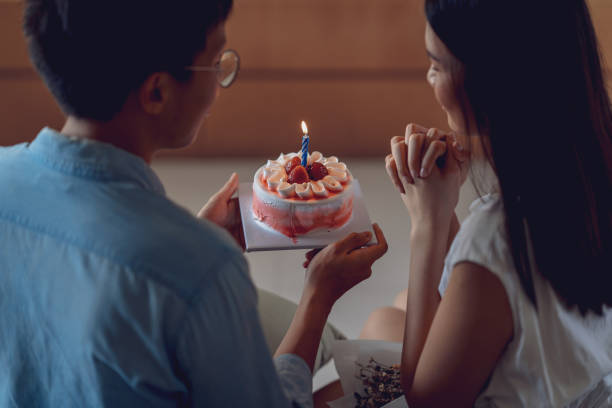 Young asian couple celebrating a private and simple birthday event at home stock photo