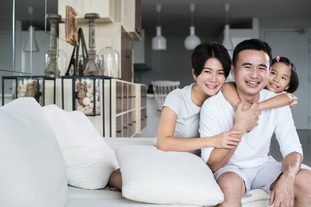 Young Asian family at home. stock photo