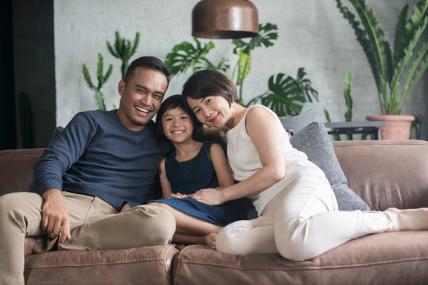 Young Asian family at home. stock photo