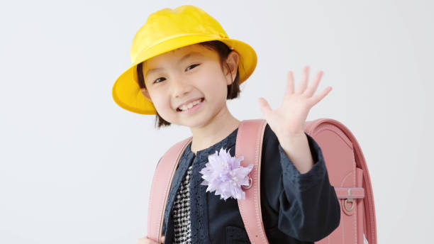 young asian girl carrying a school bag  wave goodbye asian stock pictures, royalty-free photos & images