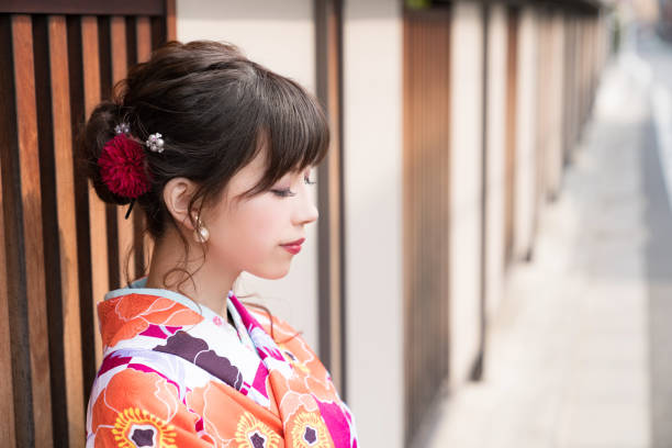Young asian girl wearing kimono (Japanese traditional clothes). Young asian girl wearing kimono (Japanese traditional clothes). furisode stock pictures, royalty-free photos & images