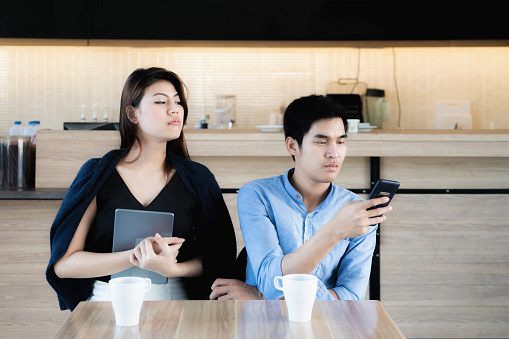 Young Asian Lover Couple Using Smartphones At Cafe Jealous Girlfriend  Peeking For Spy Her Boyfriends Phone Love And Jealous Concept Stock Photo -  Download Image Now - iStock