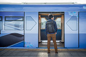 istock Young Asian man standing in front of the metro train on station platform in the city. Urban lifestyle concept 969066362