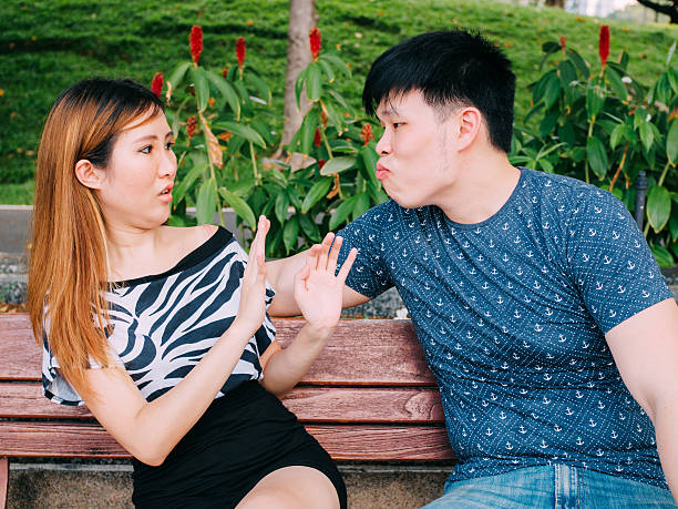 Young Asian man trying to kiss girl & get rejected Young Asian man trying to kiss a girl and gets rejected bad date stock pictures, royalty-free photos & images
