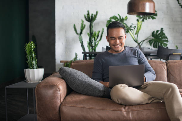 Young Asian man working at home. stock photo