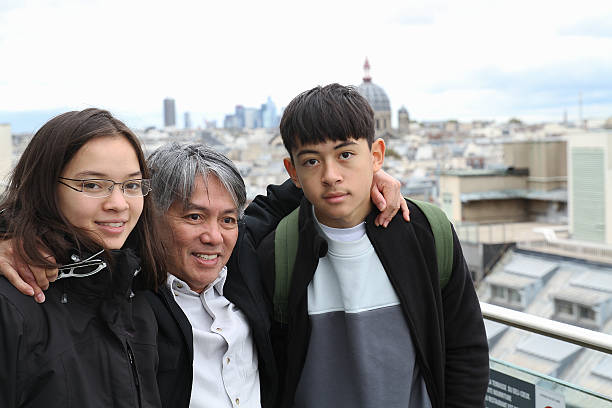 Young Asian retiree on a trip to Paris with his grandchildren stock photo