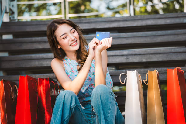 Young asian smile woman sit and hold a credit card. stock photo