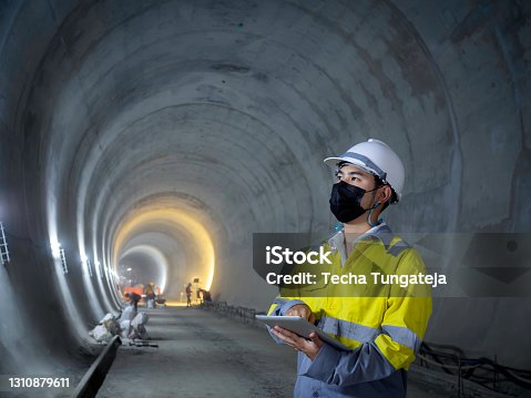 istock Young Asian tunnel engineering working at construction site. 1310879611