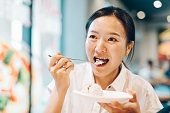 アイスクリームを食べるアジアの若い女性。