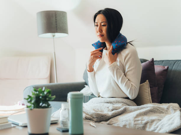 Young Asian woman sick at home stock photo