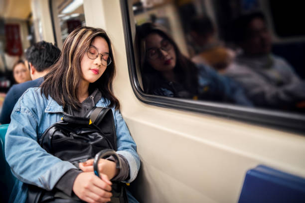 young-asian-woman-sleeping-in-a-metro-train-picture-id1150736896