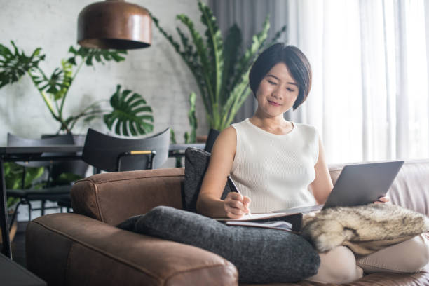 Young Asian woman working at home. stock photo
