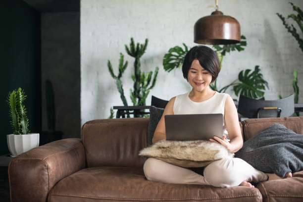 Young Asian woman working at home. stock photo