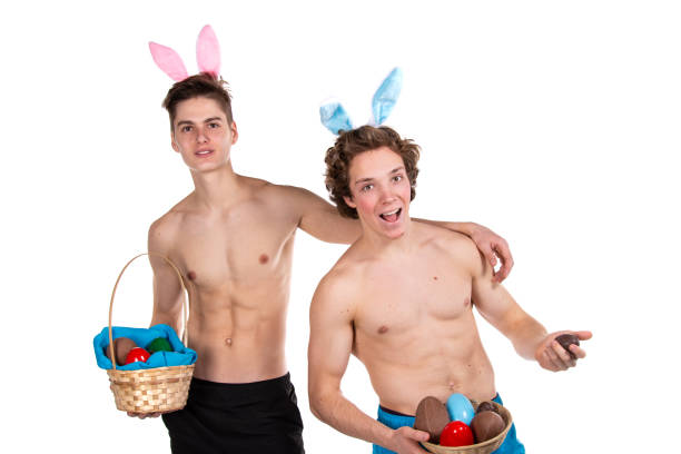 Young attractive couple for Easter in bunny costumes. White background. Holidays and weekends. vlad model photos stock pictures, royalty-free photos & images