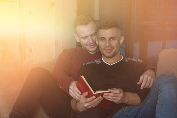 Young attractive couple resting at home. Friends at home reading books. vlad model photos stock pictures, royalty-free photos & images