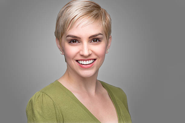 Young attractive fashionable headshot short pixie hair perfect smile teeth stock photo