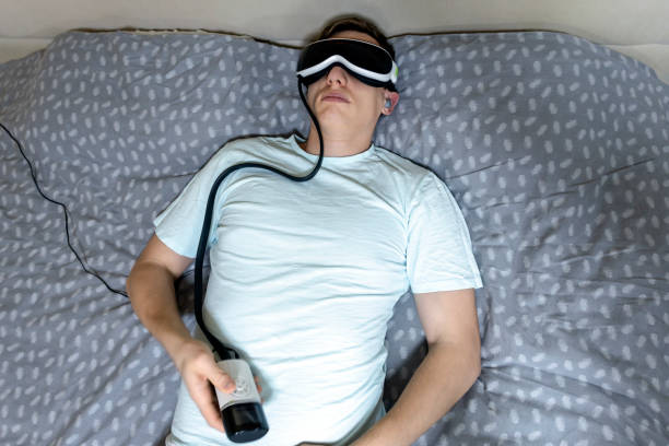 young attractive man uses an eye massager device, lying on the bed, holding a remote control young attractive man uses an eye massager device, lying on the bed, holding a remote control eye twitching stock pictures, royalty-free photos & images