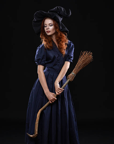 Young beautiful red-haired witch in the dark Young beautiful red-haired witch with a broom in the dark ugly skinny women stock pictures, royalty-free photos & images