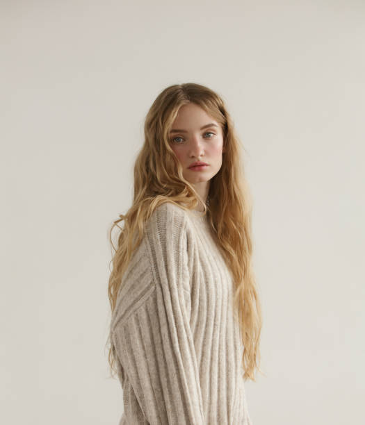 Young beautiful woman wearing beige sweater stock photo