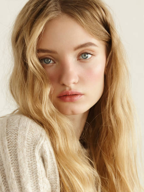 Young beautiful woman wearing beige sweater stock photo