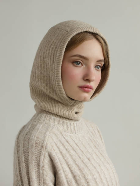 Young beautiful woman wearing knitted hood and sweater stock photo